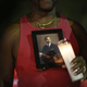 Vince Wright wears a picture of his brother Willie Wright II, who died of AIDS in 1992, as he joins with others for the Broward House and the Pride Center at Equality Park World AIDS Day Vigil and Remembrance Walk in Wilton Manors, Fla., on Dec. 1, 2015. (Joe Raedle/Getty Images)